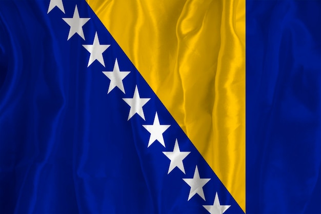 Photo the flag of bosnia on a silk background is a great national symbol fabric texture the official state symbol of the country