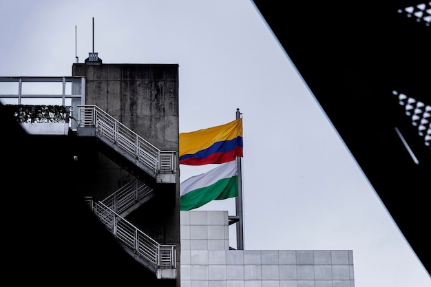 A flag on a building with a staircase in the background