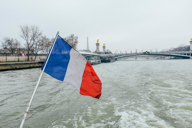 Flag by river against sky