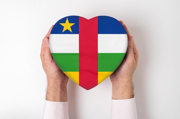 Flag of Central African Republic on a heart shaped box in a male hands White background