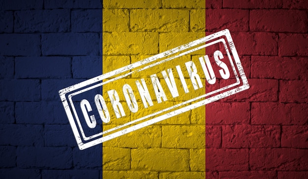 Flag of the Chad on brick wall texture stamped of Coronavirus Corona virus concept