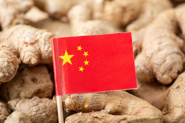 Flag of China on ginger Origin of spices trade of ginger around the world concept