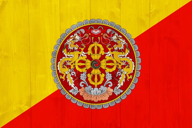 Photo flag and coat of arms of kingdom of bhutan on a textured background concept collage