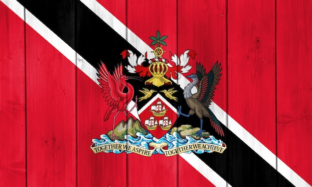 Foto bandiera e stemma della repubblica di trinidad e tobago su uno sfondo tessuto collage concettuale