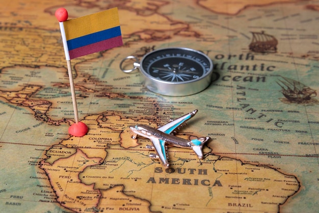 Flag of Colombia compass and plane on the world map