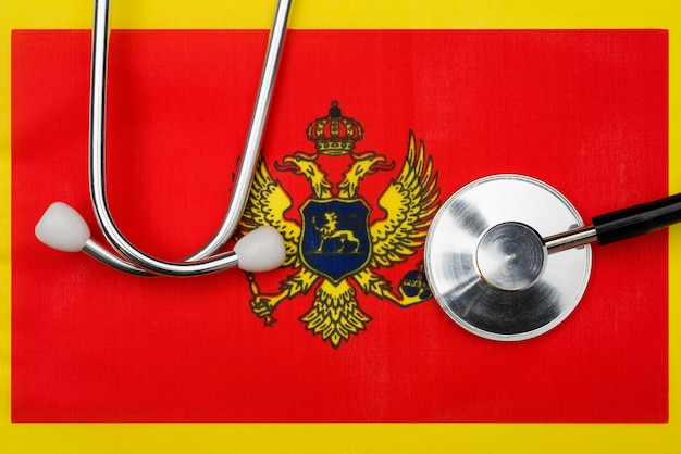 The flag of the country of montenegro and stethoscope the concept of medicine