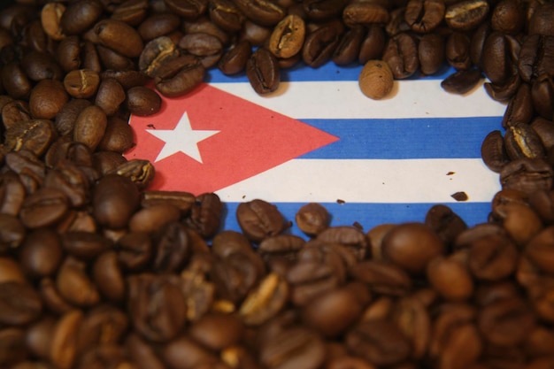 A flag of cuba sits among coffee beans.