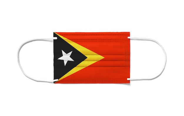 Flag of East Timor on a disposable surgical mask. White surface isolated