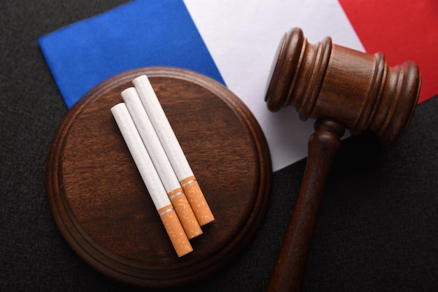 Flag of France cigarettes and Judge gavel top view Tobacco control act government duty Justice and Tobacco law