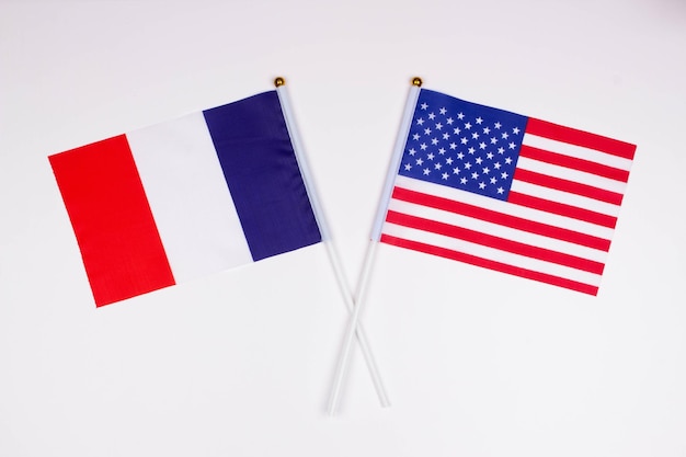 Flag of France and flag of USA crossed with each other France vs America on a white background