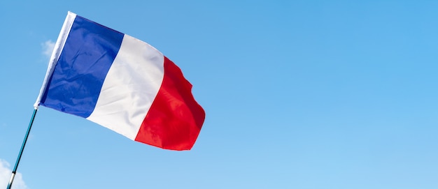 Flag of France waving in the wind in the sky