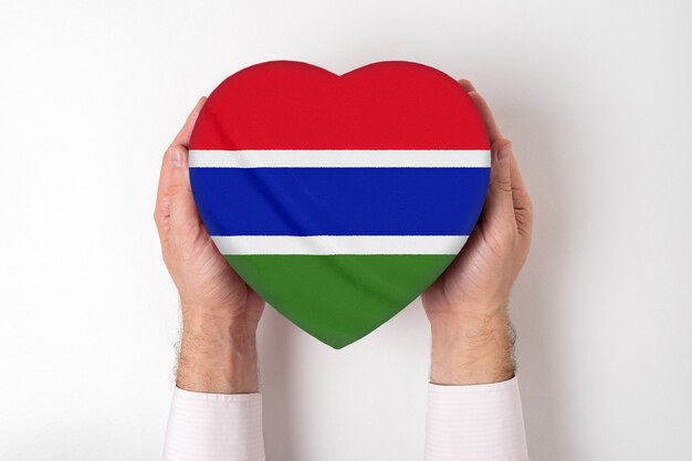 Flag of Gambia on a heart shaped box in a male hands.