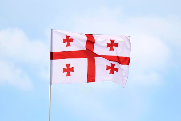 The flag of georgia is white banner with five red crosses