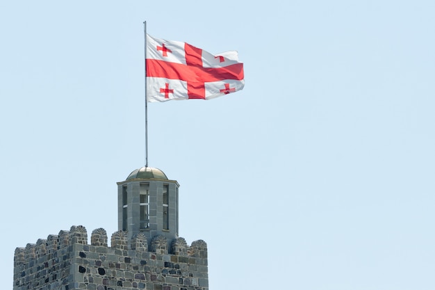 Flag of Georgia at the top of the fortress. Clear sky on the 