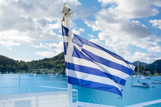 The flag of Greece on the background of the sunny day