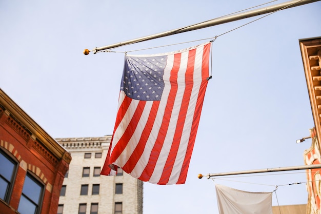 A flag hangs from a flagpole in front of a building.