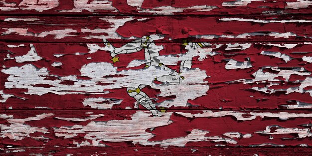 Flag of the Isle of Mann painted on a weathered wooden wall