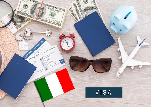 Photo flag of italy with passport and toy airplane on wooden background flight travel concept