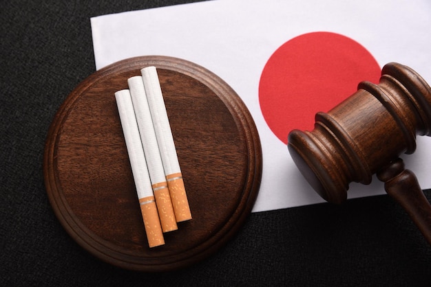 Flag of Japan cigarettes and Judge gavel Sales of cigarettes in Japan Tobacco law Tobacco control act