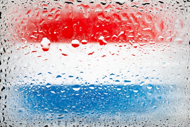 Flag of Netherlands Netherlands flag on the background of water drops Flag with raindrops