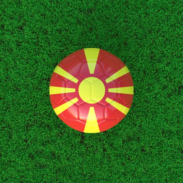 草の背景にサッカー ボールの北マケドニアの旗
