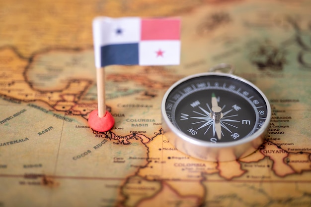 Photo the flag of panama and the compass on the world map