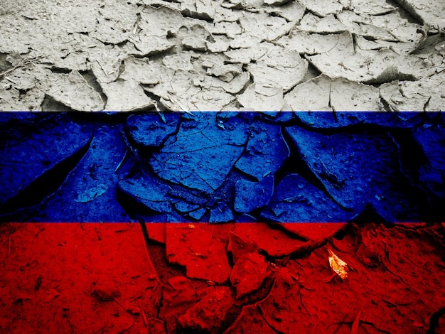 Flag of russia on the cracked dry ground