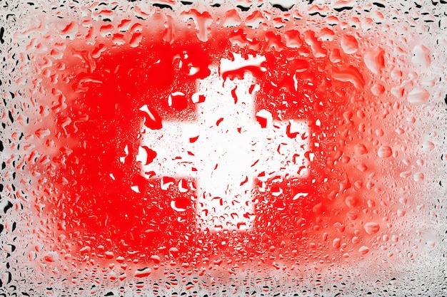 Flag of Switzerland Swiss flag on background of water drops Flag with raindrops Splashes on glass