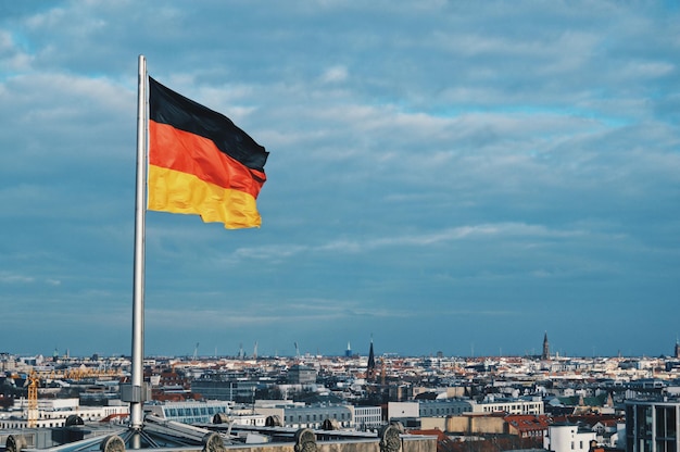 flag on terrace in city against sky
