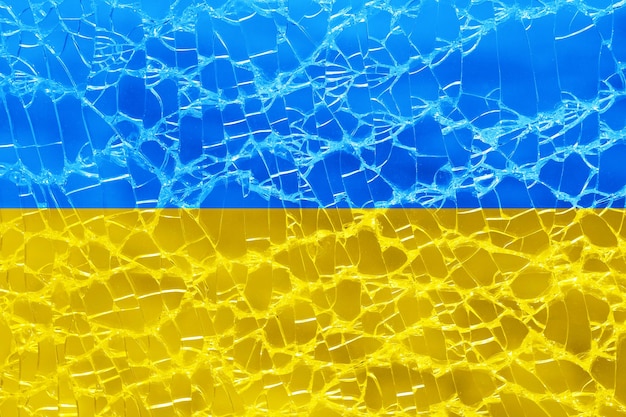 Flag of ukraine on broken glass background