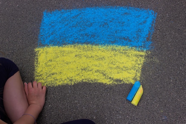 Flag of Ukraine Chalk drawing on sidewalk Creative support by children for Ukraine