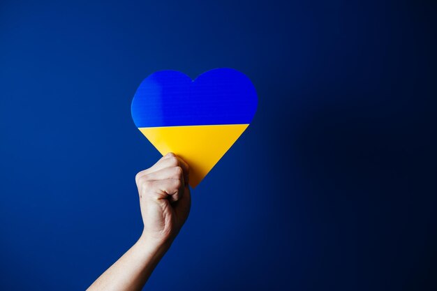 Flag of ukraine in a heart shape image showing support for the people during war