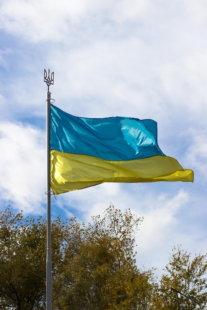 The flag of Ukraine waving in the wind Blueyellow flag with coat of arms