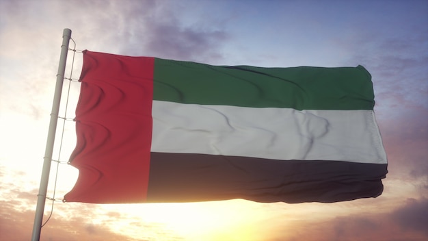 Bandiera degli emirati arabi uniti che fluttua nel vento contro il bellissimo cielo profondo al tramonto. rendering 3d.