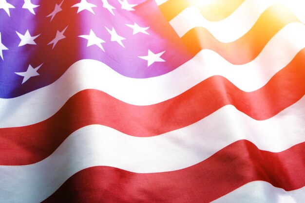 Flag United States of America in bright rays sun.