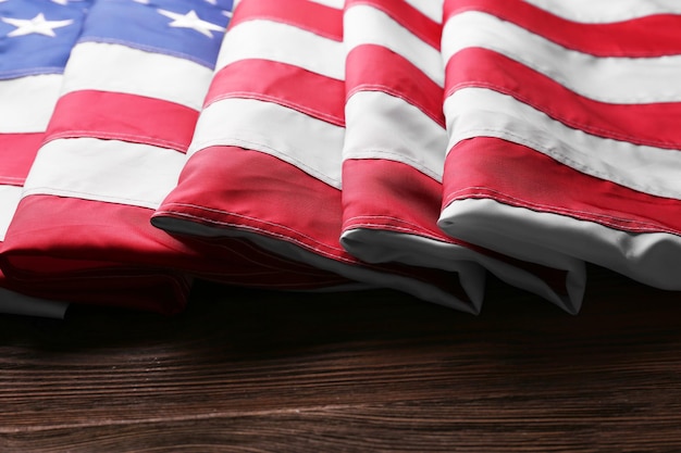 Flag of United States of America on wooden table closeup