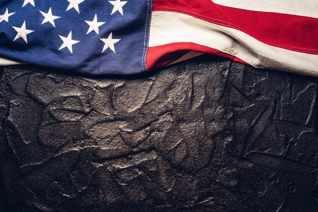 Flag of the United States on black or dark textured background.