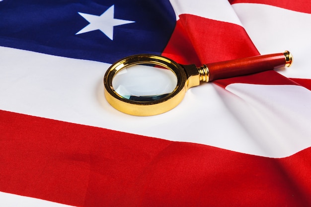 Flag of USA and a magnifying glass