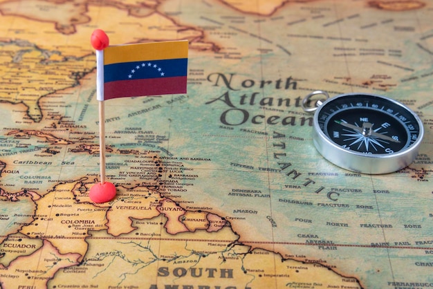 Flag of Venezuela and compass on the world map