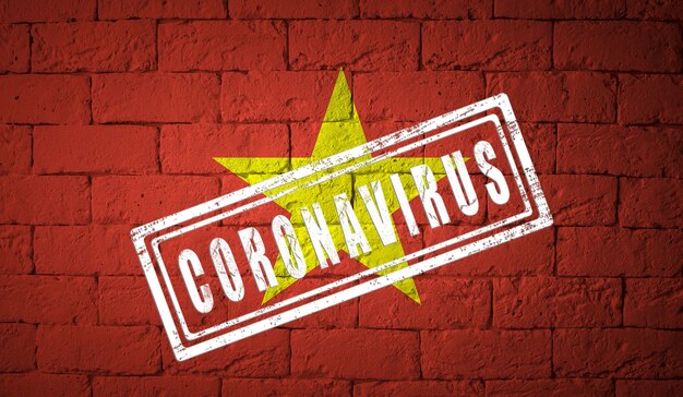 Flag of the vietnam with original proportions. stamped of coronavirus. brick wall texture. corona virus concept. on the verge of a covid-19 or 2019-ncov pandemic