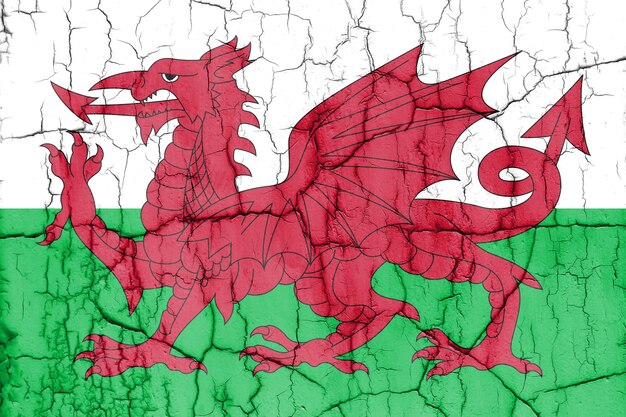 Flag of Wales on cracked wall textured background