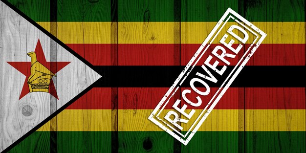 Photo flag of zimbabwe that survived or recovered from the infections of corona virus epidemic or coronavirus. grunge flag with stamp recovered