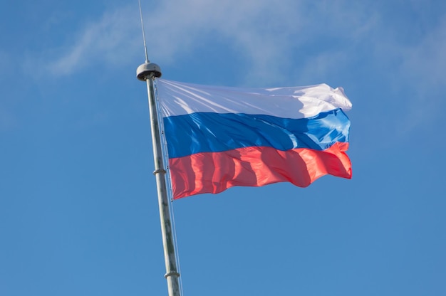 On the flagpole is developing in the wind the flag of Russia.