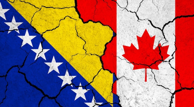 ひび割れた表面の政治関係概念上のボスニア・ヘルツェゴビナ対カナダの国旗