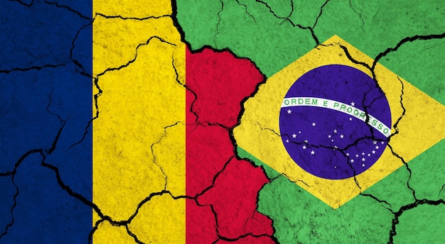 Photo flags of chad and brazil on cracked surface politics relationship concept