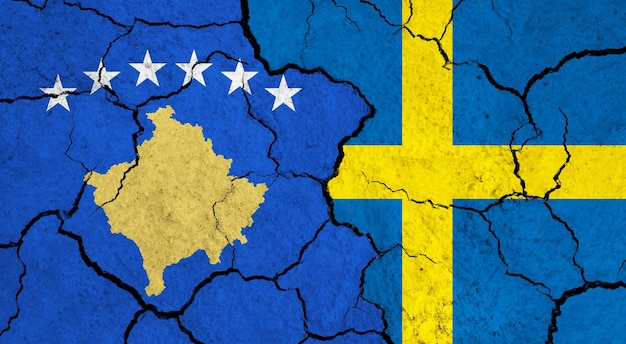 Photo flags of kosovo and sweden on cracked surface politics relationship concept