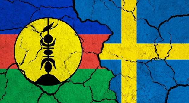 Flags of New Caledonia and Sweden on cracked surface politics relationship concept