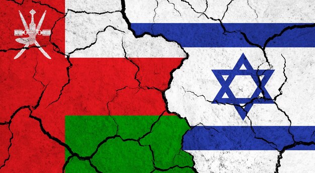 Flags of Oman and Israel on cracked surface politics relationship concept