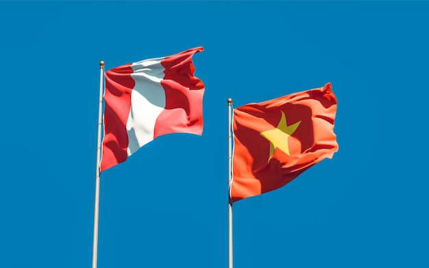 Flags of Peru and Vietnam on sky background