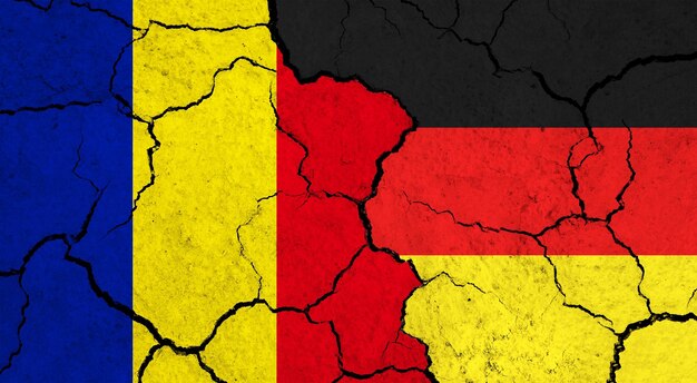 Flags of romania and germany on cracked surface politics relationship concept